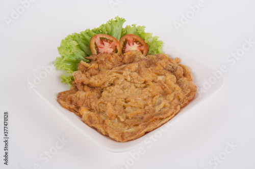 Omelet with vegetables in ceramic plate isolated on white background, It's popular traditional Thai style food.