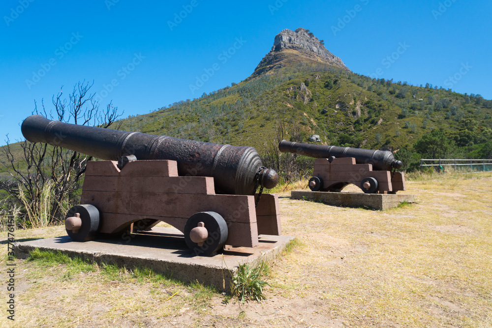 old historical pair of cannons on hill with Lions Head in the background, Cape Town, South Africa