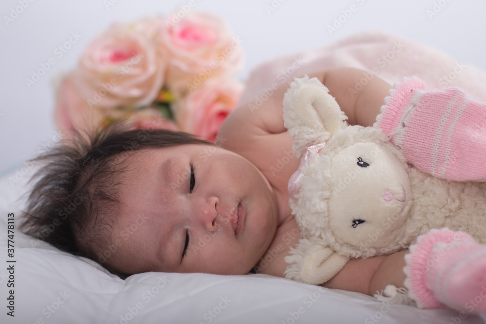 Cute newborn asian girl sleeping on the bed. Cute newborn asian girl sleeping on the bed.