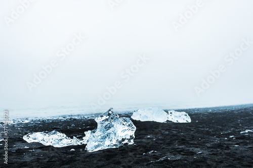 Ice on the black volcanic sand in Jokulsarlon ice beach, Iceland. Coast of Atlantic ocean