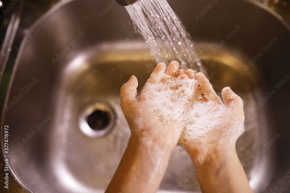 Fototapeta premium Hygiene rules. Hand washing before meals. Antibacterial treatment of hands with soap. A way to prevent virus infection. Coronavirus protection.
