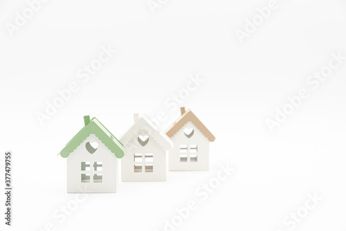 Small conceptual houses isolated on white background with plenty of copy space. Concept of home. Real Estate concept.