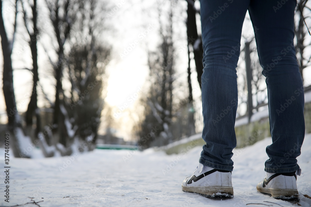 A man walks through the city on snowy winter day. A man walks through the city on snowy winter day.