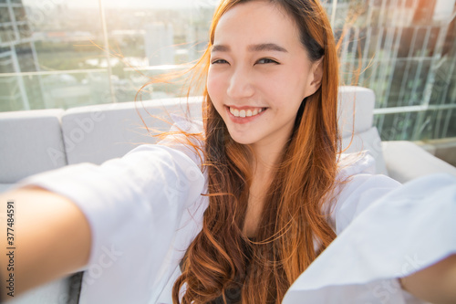 Happy young travel asian woman using mobile phone and selfie in the city Bangkok, Thailand, Travel vacation city skyscrapers concept.