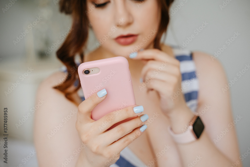 Blogger girl sits in a cell phone for account development. Close-up of a phone for work and communication. Freelancer on isolation. Blogger girl sits in a cell phone for account development. Close-up of a phone for work and communication. Freelancer on isolation.