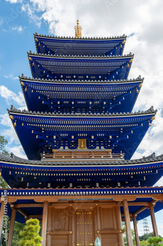 Blue colored five-storied pagoda of Nakayamadera temple in Takarazuka city, Hyogo, Japan.  Translation: two Chinese characters on the plate mean 