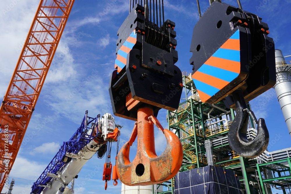 Fototapeta premium Close up crane hook for mobile crane in factory and background is a chemical plant Industrial estate.