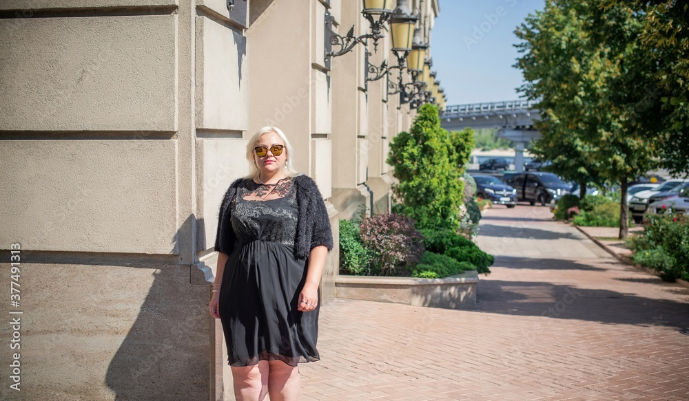 Plus size woman, American or European appearance walks in the city enjoying life. A young lady with excess weight, stylishly dressed in the center of the city. Natural beauty Plus size woman, American or European appearance walks in the city enjoying life. A young lady with excess weight, stylishly dressed in the center of the city. Natural beauty