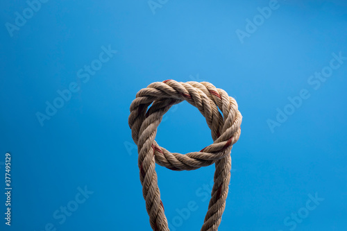 Rope with a knot on blue background