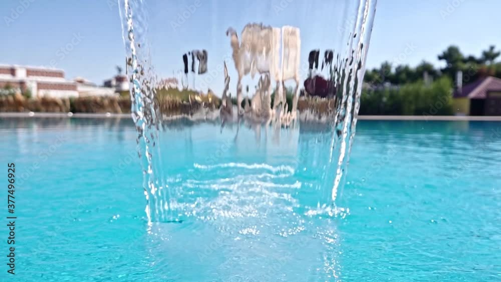 Water Curtain Close-Up, Close-up looking through a curtain of water pouring into a pool from a waterfall in slow motion. Water Curtain Close-Up, Close-up looking through a curtain of water pouring into a pool from a waterfall in slow motion.