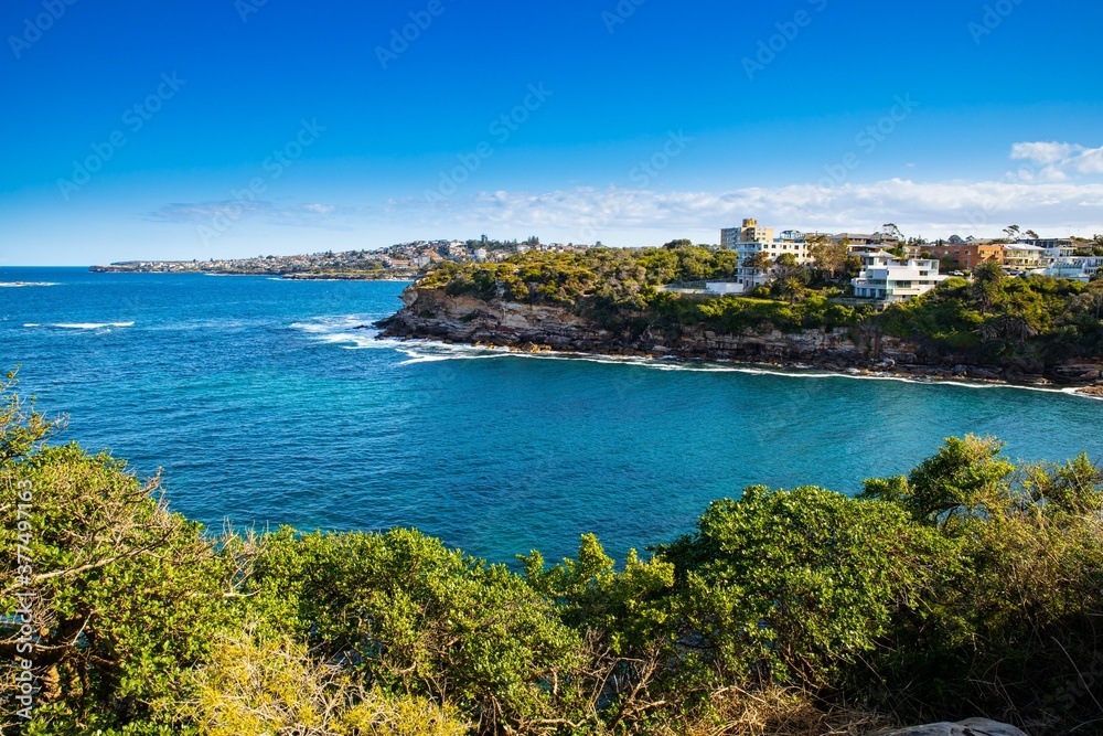 Gordons Bay surrounded by high rock cliffs and houses, turquoise blue waters great for swimming Sydney NSW Australia