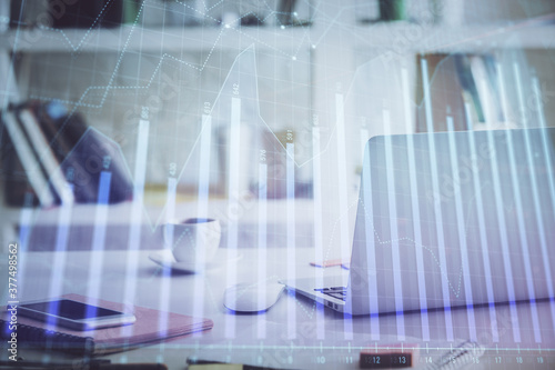 Stock market graph and table with computer background. Double exposure. Concept of financial analysis.