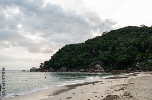 Tropical beach with a crystal blue water with a mountain in Thailand.