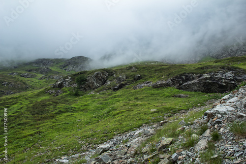 Moody mountain landscape with fog and mist