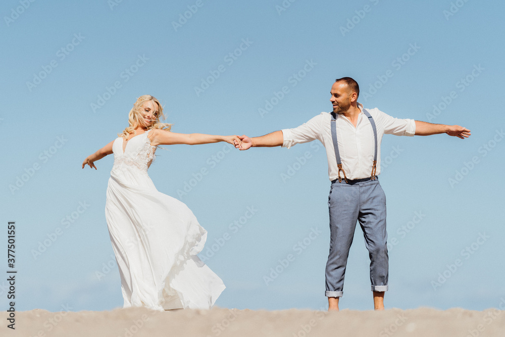 happy newly married couple dancing on the beach. Wedding on the beach happy newly married couple dancing on the beach. Wedding on the beach