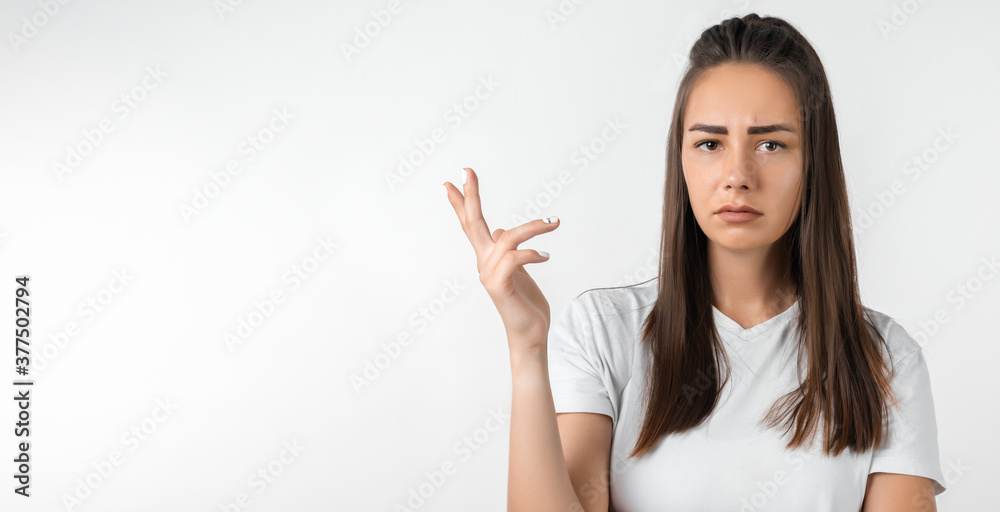 Studio shot of frustrated female gesturing with raised palm, frowning, being displeased and confused with dumb question Studio shot of frustrated female gesturing with raised palm, frowning, being displeased and confused with dumb question