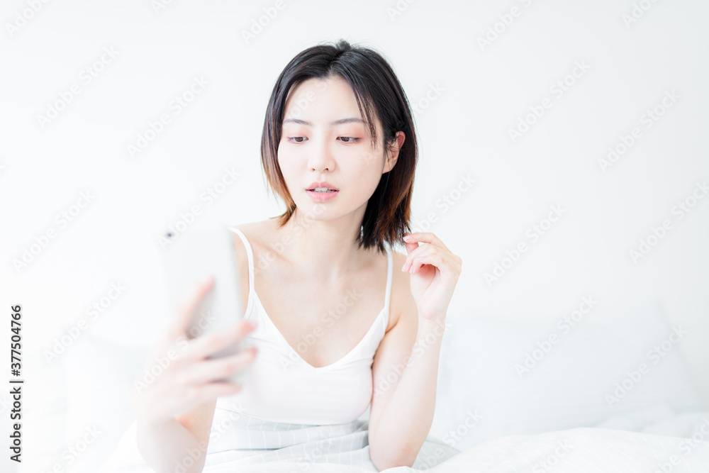 Asian woman using mobile phone indoors Asian woman using mobile phone indoors