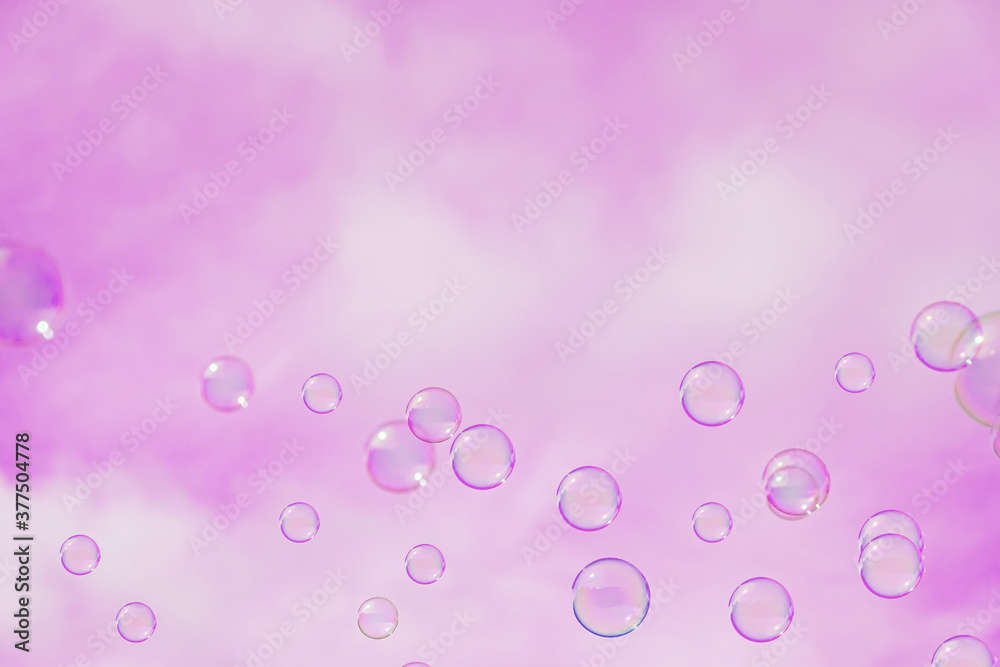 Abstract background, soap bubbles on pink sky background. Copy space for text.