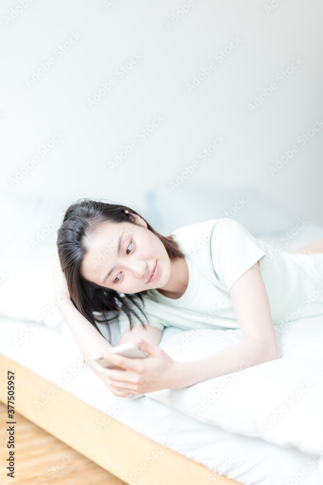 Asian woman using mobile phone indoors Asian woman using mobile phone indoors