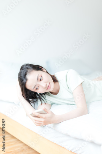 Asian woman using mobile phone indoors