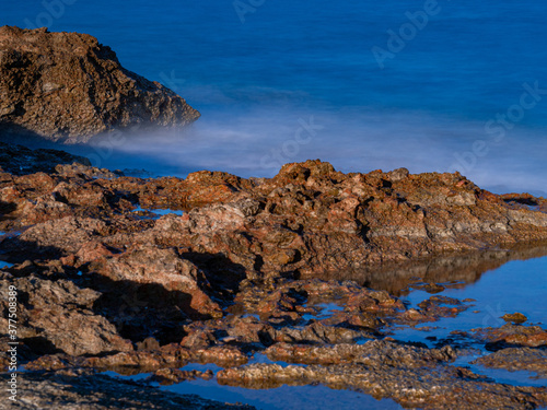 sea water hitting the shore stones with silk effect