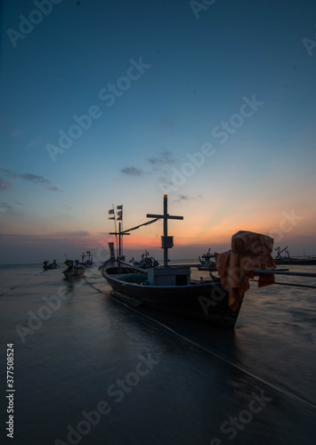 Beautiful light and sky of sunset view with fisherman boat parking 