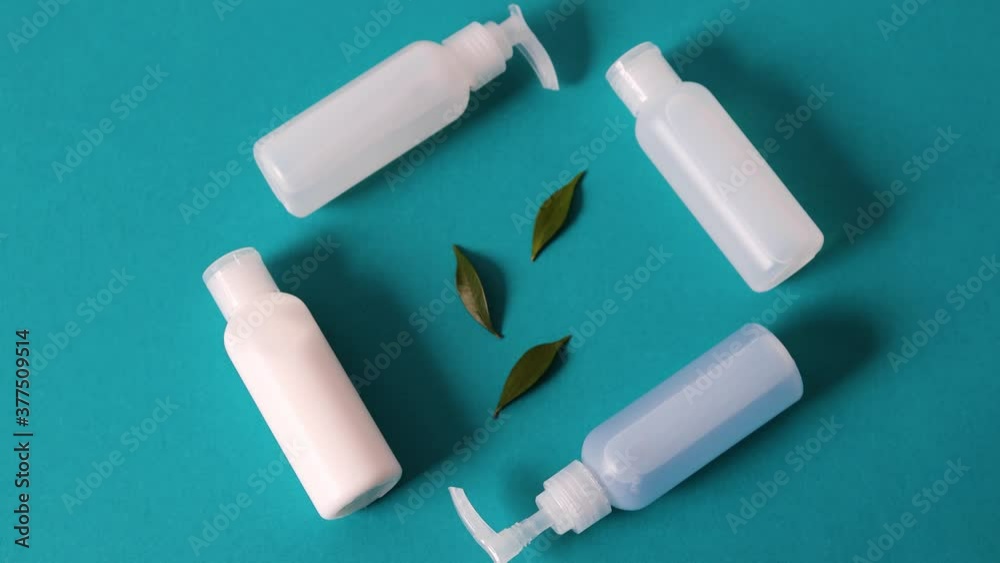 natural beauty products, group of lotions and moisturizers with green leaves and camera tilting natural beauty products, group of lotions and moisturizers with green leaves and camera tilting