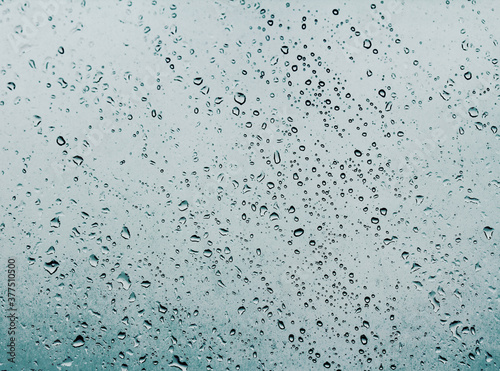 Water drops on glass against the storm sky