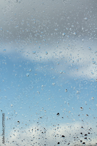 water drops on glass against blue sky