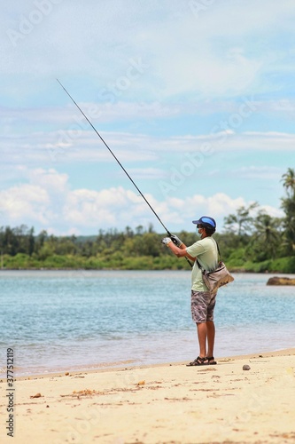 man fishing on the beach