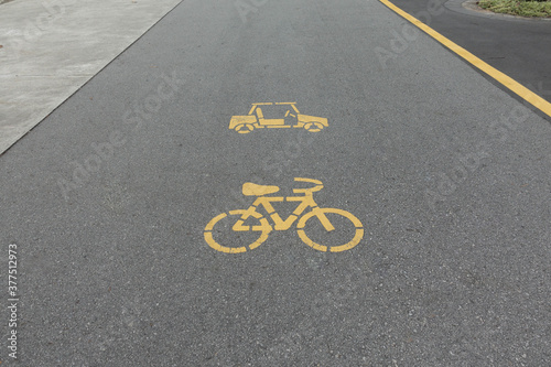 Empty bicycle way for bike in a park with cart sign