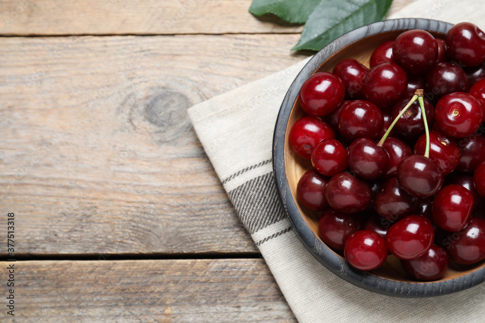Sweet juicy cherries on wooden table, flat lay. Space for text Sweet juicy cherries on wooden table, flat lay. Space for text