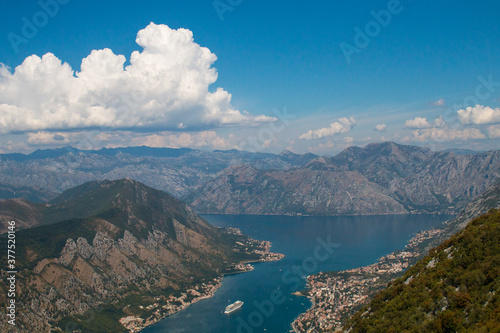 Bay of Kotor from the heights. View from Mount Lovcen to the bay. View down from the observation platform on the mountain Lovcen. Mountains and bay in Montenegro. The liner near the old town of Kotor. © Martina