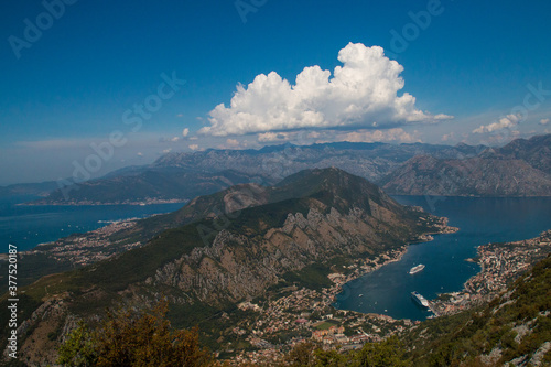 Bay of Kotor from the heights. View from Mount Lovcen to the bay. View down from the observation platform on the mountain Lovcen. Mountains and bay in Montenegro. The liner near the old town of Kotor. © Martina
