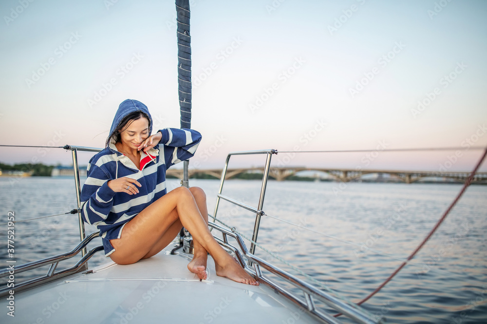 Beautiful girl resting on a yacht at sunset Beautiful girl resting on a yacht at sunset