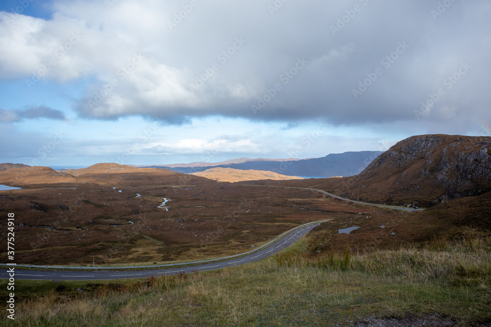 Dark clouds cutting the road in Scottish Highlands 