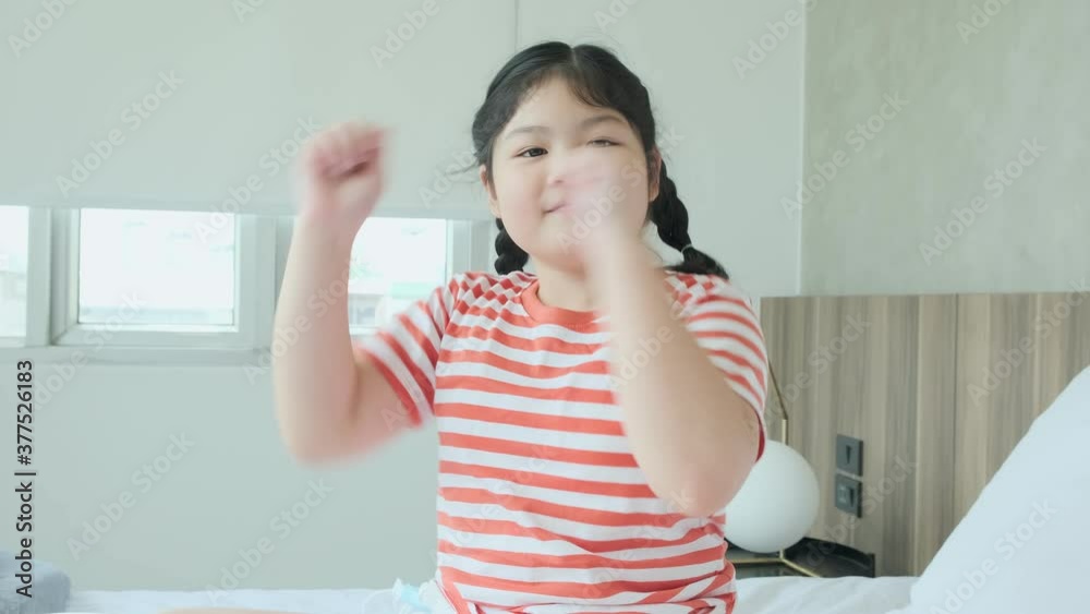 cute pretty young asian female casual cloth dance jump and singing with cheerful and happiness on white soft bed 4k slow motion footage cute pretty young asian female casual cloth dance jump and singing with cheerful and happiness on white soft bed 4k slow motion footage