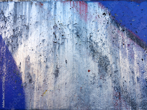 Abstract, damage to walls with many colors. Style of landscape. Rough concrete surface with cracks, scratches and paint stains. Great background or texture.