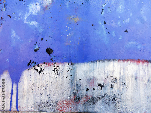 Abstract, damage to walls with many colors. Style of landscape. Rough concrete surface with cracks, scratches and paint stains. Great background or texture.