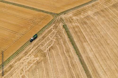 Bird's eye view of harvested grain fields and a tractor in the Taunus / Germany in late summer