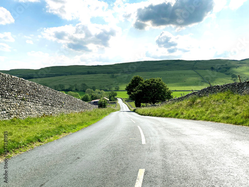 The B6160, road to Kettlewell, with dry stone walls, and hills in the distance near, Kettlewell, Skipton, UK photo