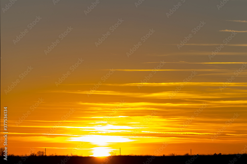 Beautiful sunset sky with colorful clouds in winter. Scenic sunset over sea surface. Natural scenery, beautiful landscape Beautiful sunset sky with colorful clouds in winter. Scenic sunset over sea surface. Natural scenery, beautiful landscape