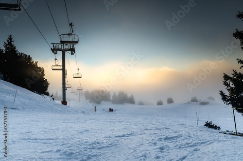 Ski lift at the Alps on the slopes photo