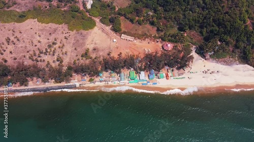 Drone footage Fly over the beautiful deserted Kerim Beach with a beach shack in Goa India at sunny day photo