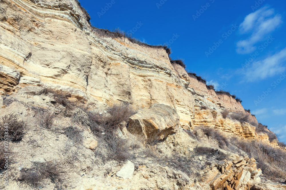 Rockslide. Mountain landslide in an environmentally hazardous area. Large cracks in earth, descent of large layers of earth blocking road. Mortal danger of dam at foot of landslide slopes of mountain