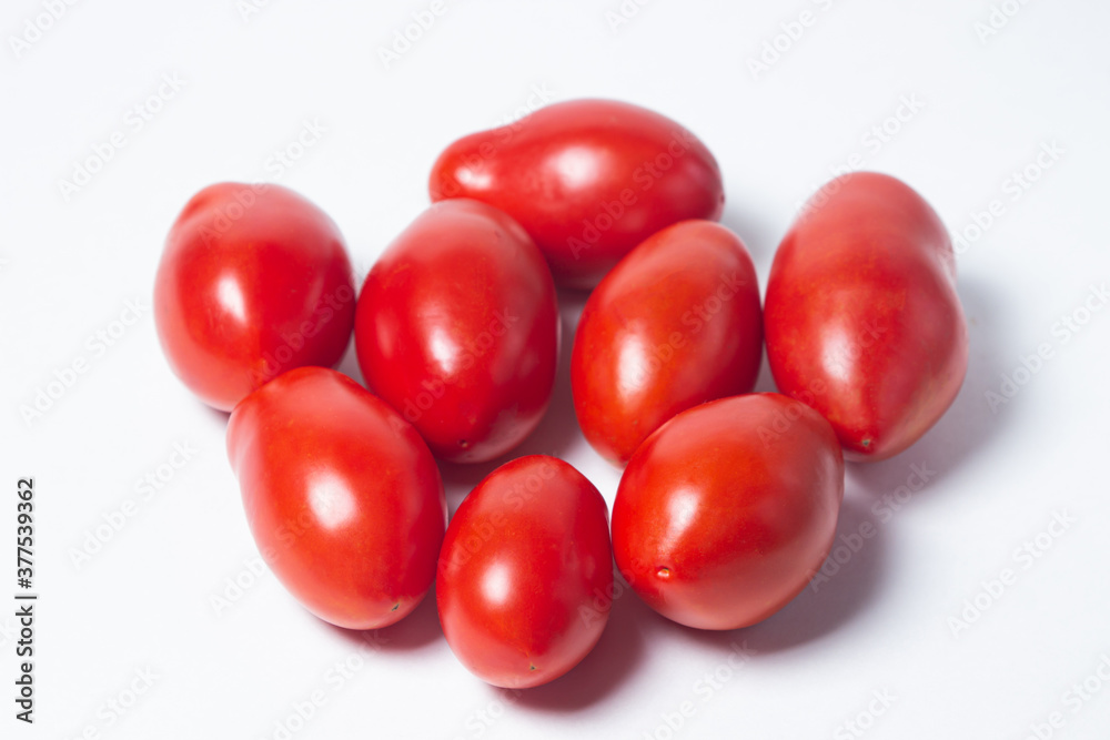 Tomatoes on a white background. Red tomatoes lie in a pile Tomatoes on a white background. Red tomatoes lie in a pile
