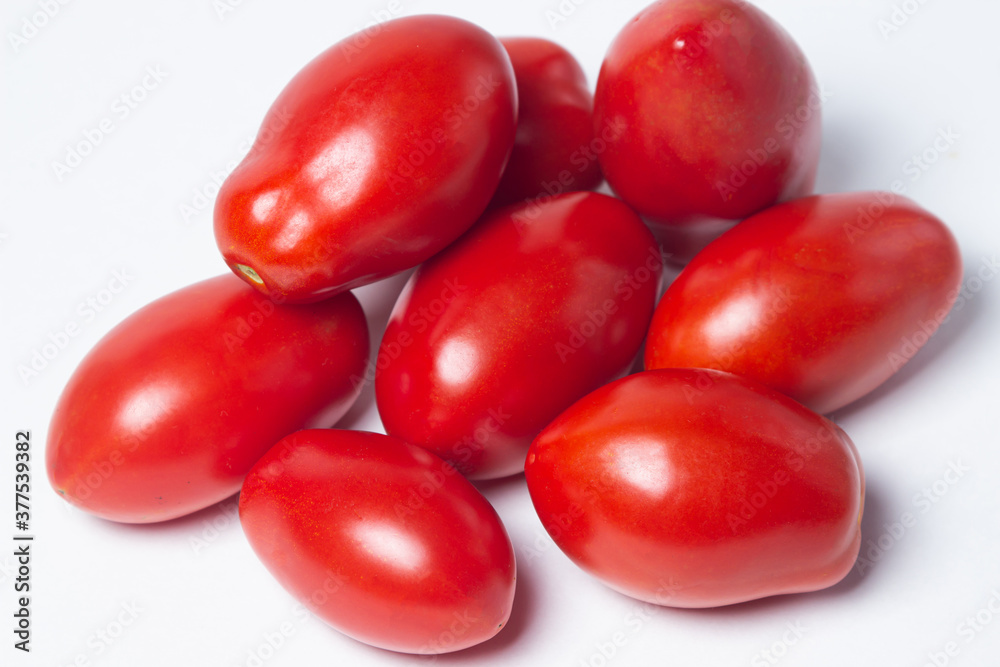 Tomatoes on a white background. Red tomatoes lie in a pile Tomatoes on a white background. Red tomatoes lie in a pile