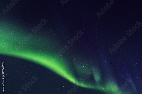 Night starry sky and Northern lights. Green aurora borealis