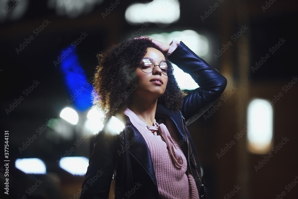 Fototapeta premium Black girl portrait in night city lights