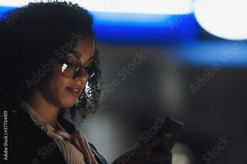 Black girl portrait in night city lights